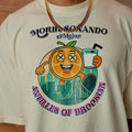 T-shirt with a colorful graphic design featuring an orange character and text on a beige background.