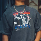 Person wearing a t-shirt with 'One Island One Love' graphic design.