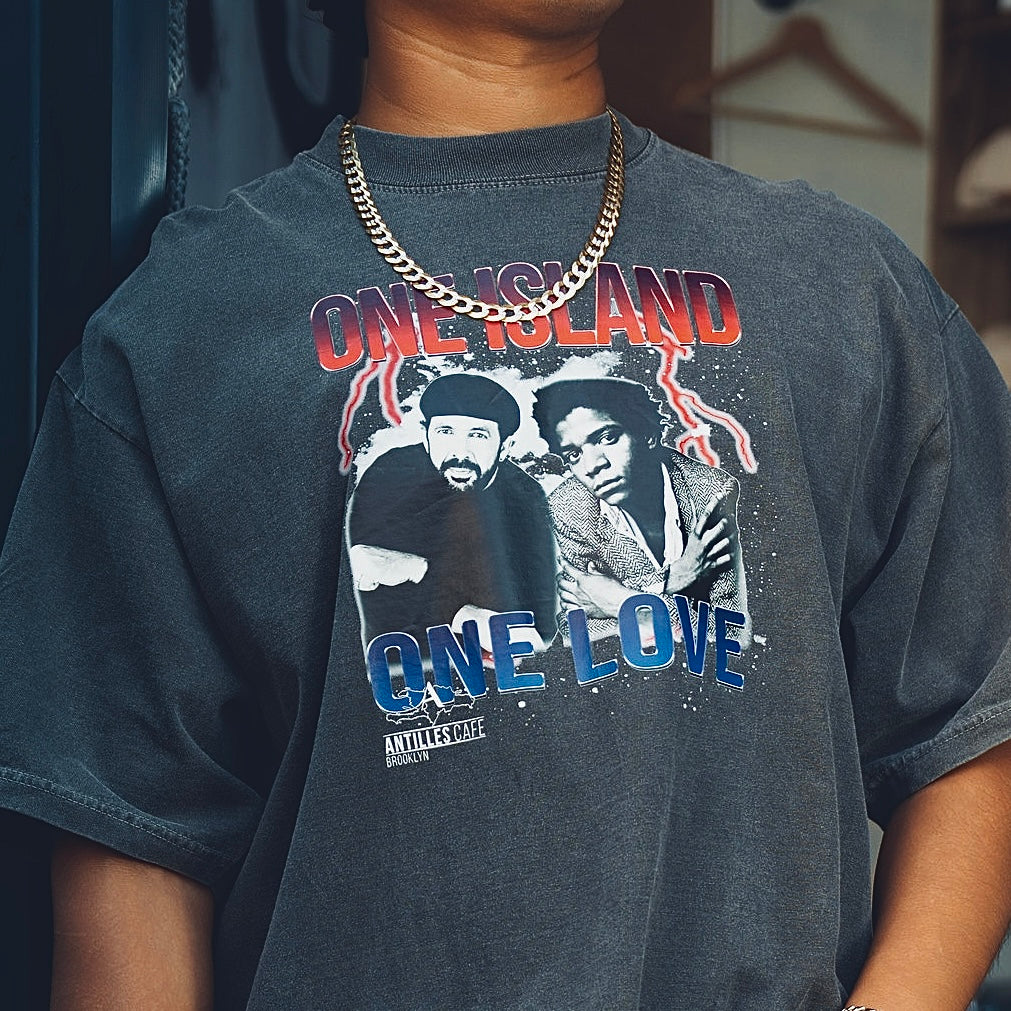 Person wearing a t-shirt with 'One Island One Love' graphic design.